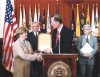 Dennis Wyant presenting a special award to the U.S. Postal Service in honor of them providing 100 years of providing free matter for the blind. Pictured from right to left, John Hanchette, Dennis Wyantt, Richard Schneider, and Deborah K. Willhite of the USPS.